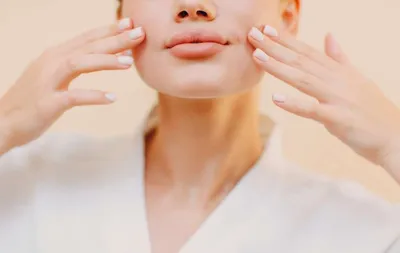 A beautiful woman touching her face