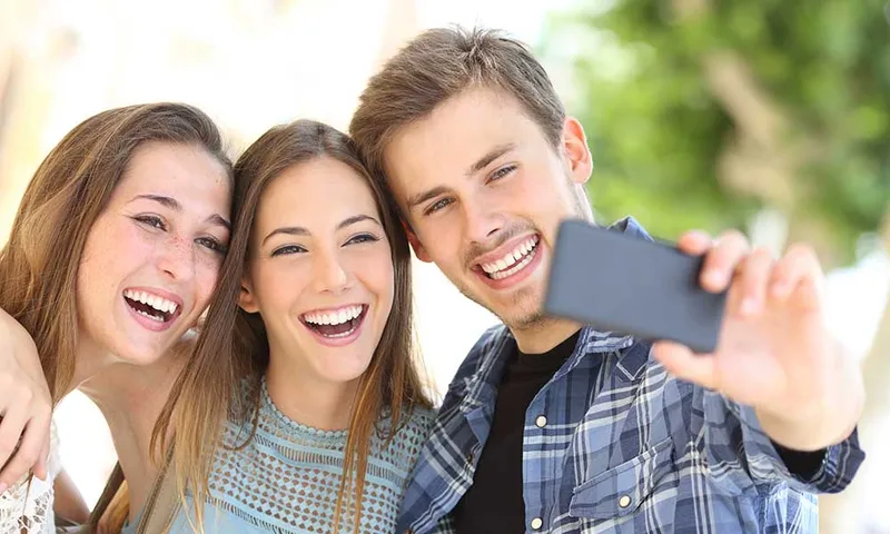 A woman smiling confidently, showcasing the long-term aesthetic results of well-maintained dental bonding.